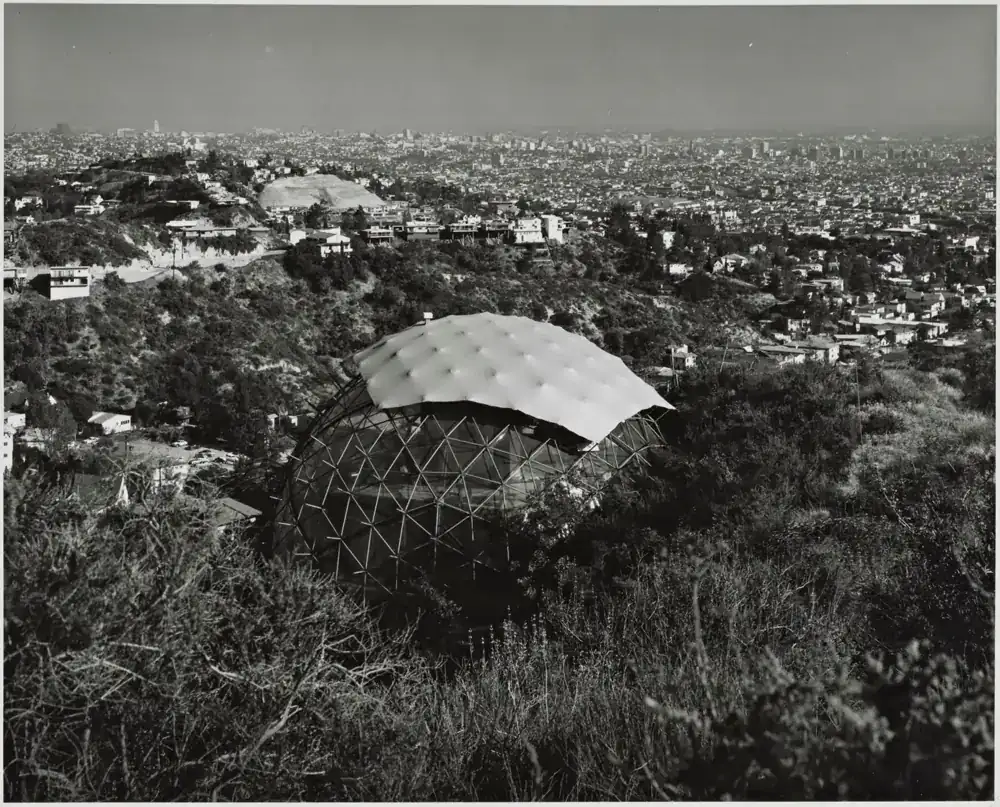 The half-skinned dome on its hillside with the city spread out below