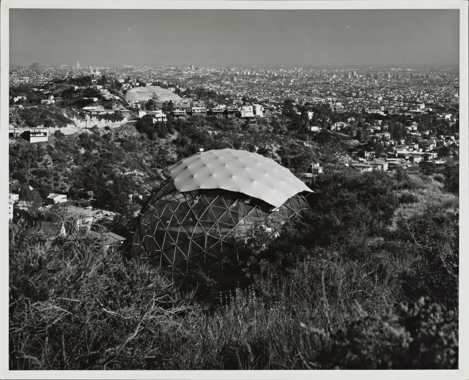 Julius Shulman’s print of the geodesic dome half-skinned on its hillside at 2949 Durand Drive, with the city spreading out below